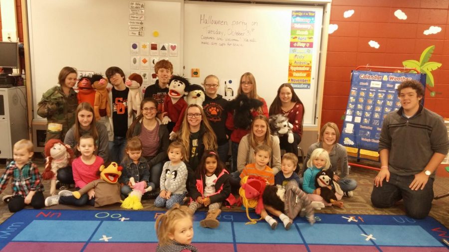 Members of the PHS Speech and Debate team display their puppets with the preschoolers.