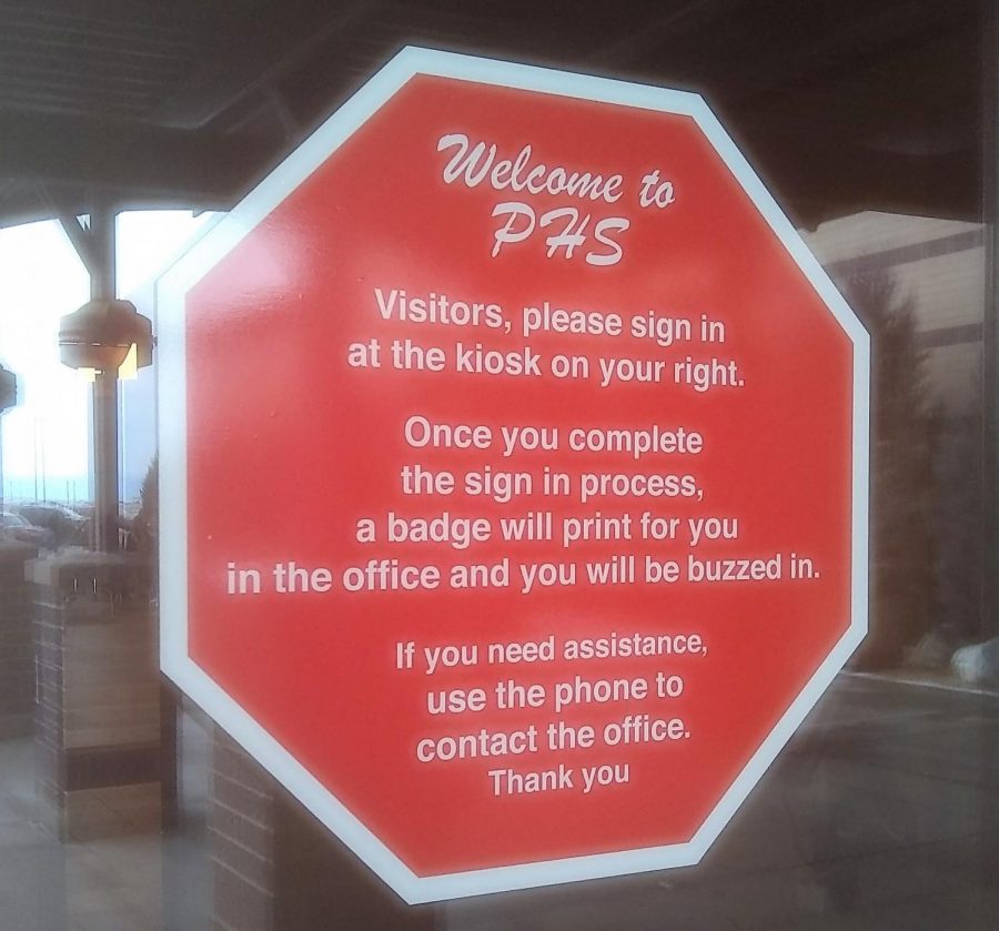 A sign at the main entrance to PHS reminds visitors what is required to enter the building.