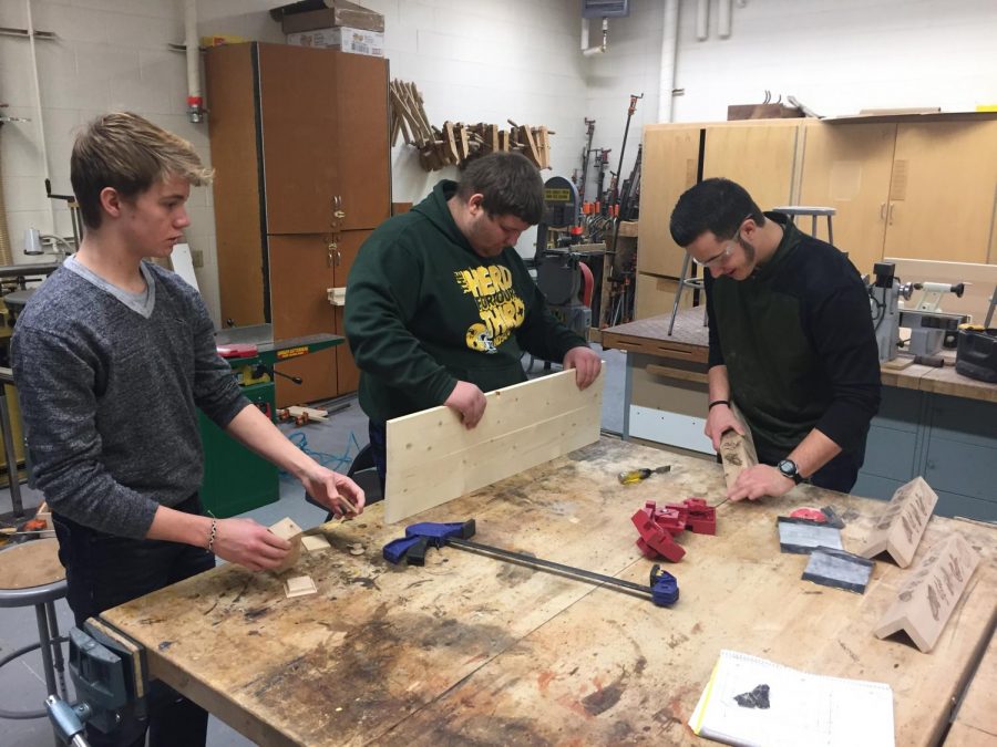(From left) Students Dylan Preator, Bryce Johnson and Gabe Katz work on their woods projects.
