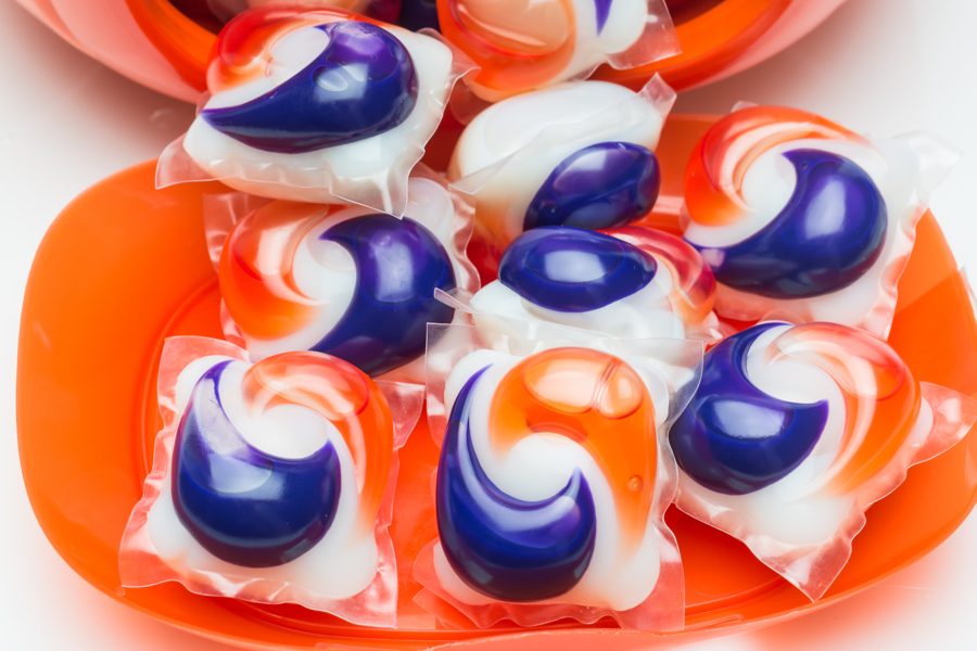Miami, Fl, USA - October 16, 2013: A close up shot of an open fish bowl shaped plastic vessel containing 62 Tide Brand Pods capsules. Each dissolvable capsule consists of pre- measured amounts of detergent,stain remover and brightener for one load of laundry.