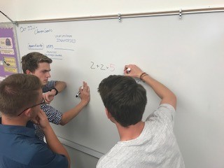 (From Left) Juniors Jay Cox, Devin Ott and Aidan Jacobson work together to solve the math problem. 