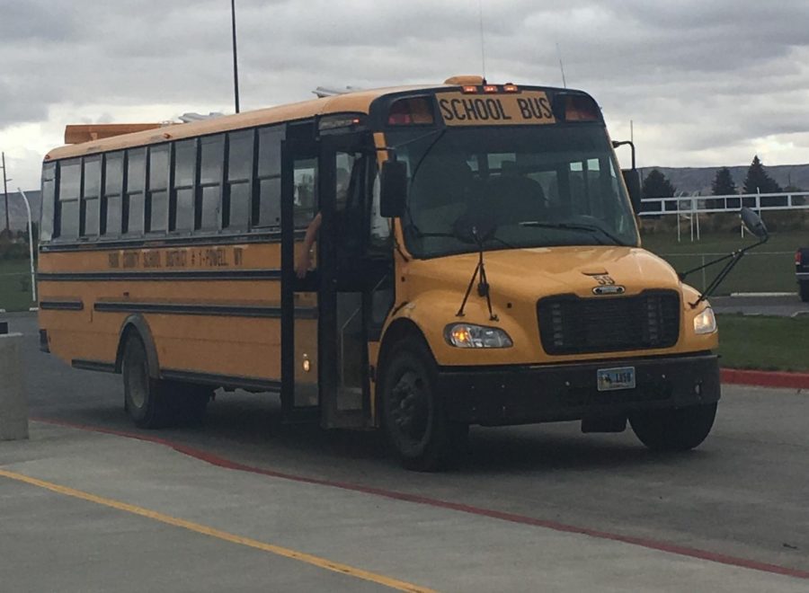 Students load a bus after school behind PHS.