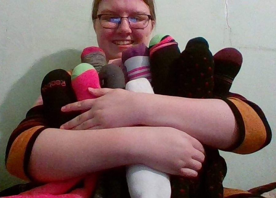 PHS Junior Hannah Hawley, poses with the sock monkeys she is working on.