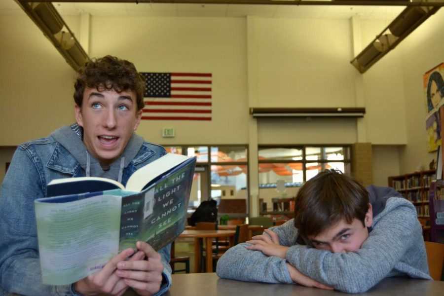 Ben Whitlock (left) looks up from his book as Riley Schuler accompanies him in the library on Nov. 29.