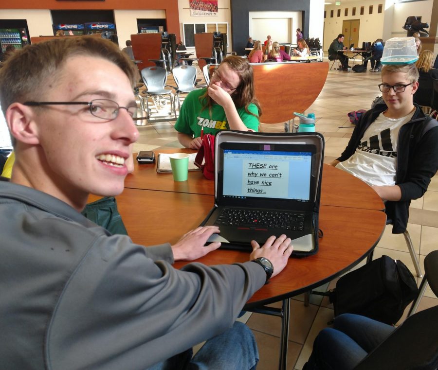 Senior Alan Merritt poses sarcastically with senior friends Lane Summers and Takota Hammond. On the computer, it reads these are why we cant have nice things.