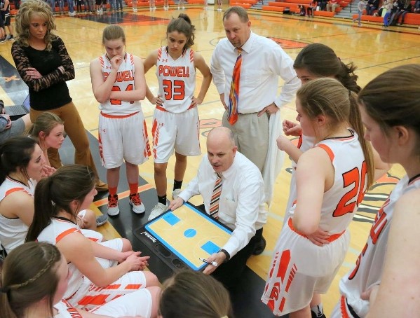 The Lady Panther basketball team listens as coach Scott McKenzie talks during a timeout against the Cody Fillies during the 2017-18 season.