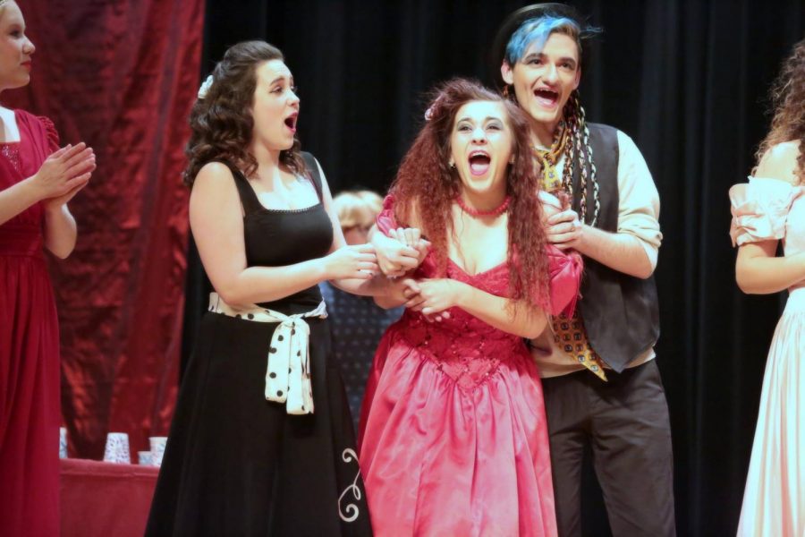  (left to right) 2018 graduate Madison Reidinger, who played Heather Wellington, cheers for 2016 graduate Kateri Schneider, who played Whitley Whitiker as she squeals for joy after she heard her named called as prom queen. Junior Izaiah Zapata, who played one of the roles as a varsity cheerleader, cheers fro Schneider after her nomination in The Awesome 80’s Prom performance on Dec. 7-8.