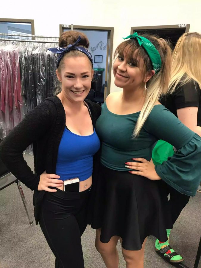 Senior Alyssa Gould (left) and former student junior Kailey Jurado pose in the choir room on the Homecoming dress up day, color day. 