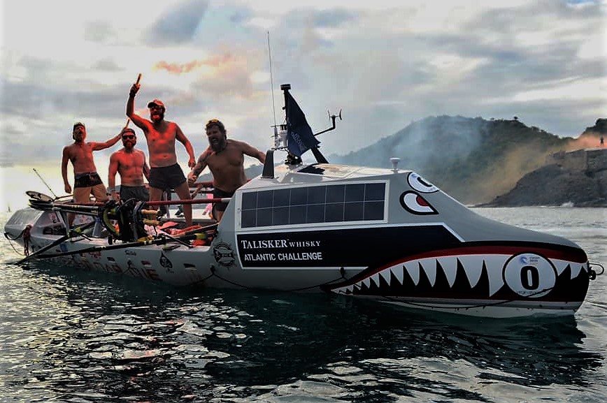 The all-American Military Veteran team “Fight Oar Die” celebrates as they finish the Talisker Whiskey Atlantic Challenge from the Canary Islands to Antigua.