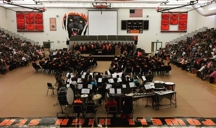 The graduating class of 2018 and audience give their attention to the Powell High School choir.
