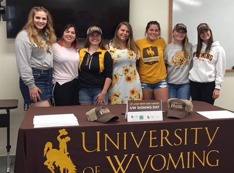 (From left to right) Seniors McKennah Buck, Ariana Rodriguez, Sadie Wenzel, Kenadee Bott, Jasmyne Lensegrav, Sierra Sanders and Brylee Schuler pose for a picture after the University of Wyoming certificate signing at the Powell Research and UW Extension Center May 14.