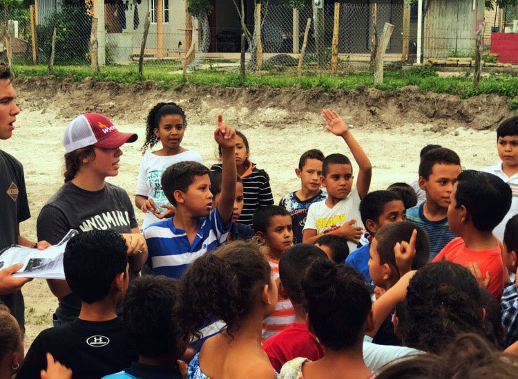 (Left to Right) Current junior Jace Bohlman and Ms. Katie King teach a group of students from La Venta.