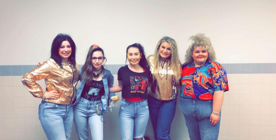 Seniors (from left) Kiya McIntosh, Kalli Ashby, Tenna DesJarlais,  McKenzie Clarkson and Joey Mickelson pose for a picture for homecoming weeks 80’s day. 
