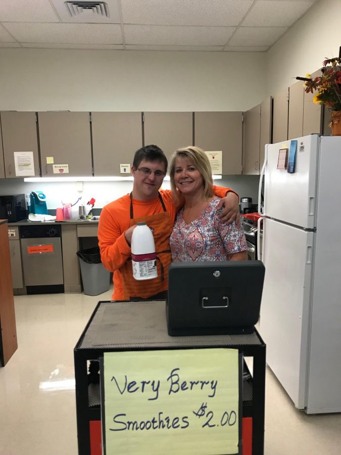 (Left to Right) Matthew Pool and Mrs. Jacque Hunter stand together behind their smoothie cart. 
