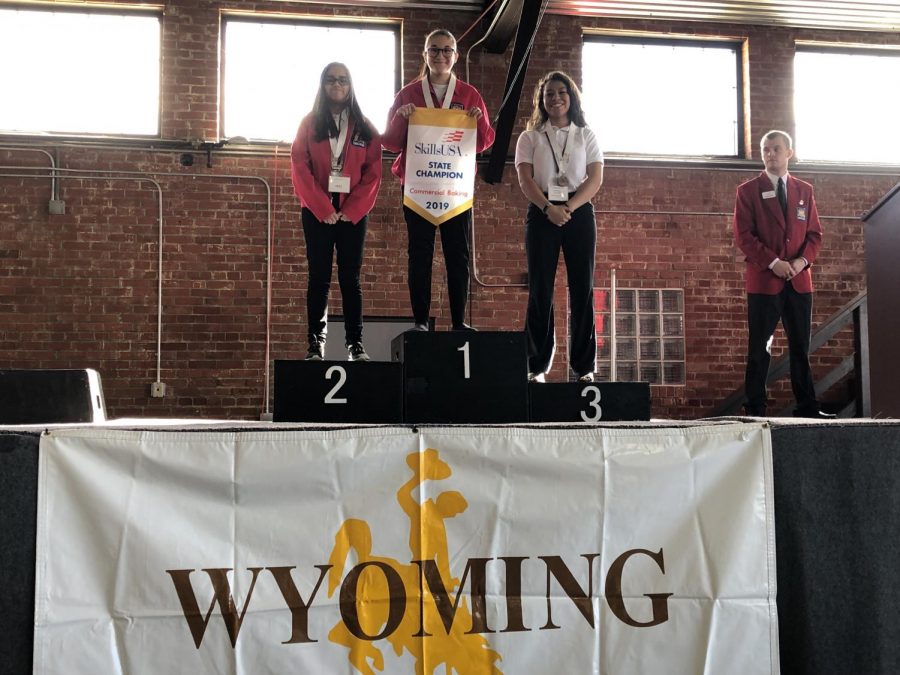Junior+Maggie+Cappiello+stands+on+the+first-place+podium+after+winning+the+Commercial+Baking+event+at+the+2019+Wyoming+SkillsUSA+state+competition+in+Casper.