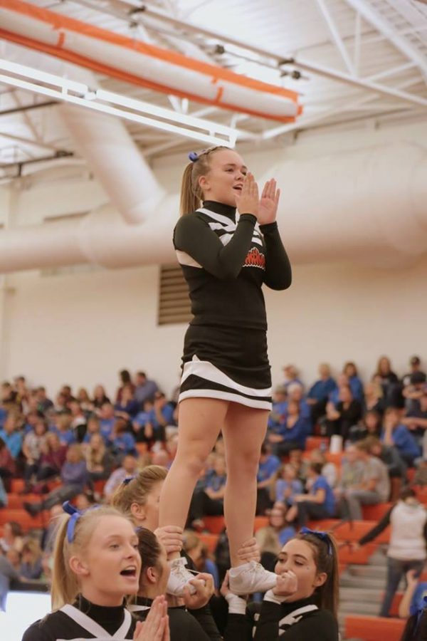 Senior Kaitlyn Decker cheers for the crowd, during a basketball timeout last year. 