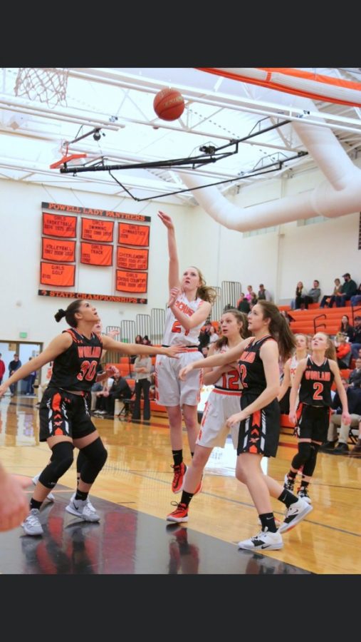 Senior Sidney O’Brien blocks a Worland Warrior while junior Hailee Hyde takes her chance at a shot during the Powell vs Worland game Friday, Jan. 24.