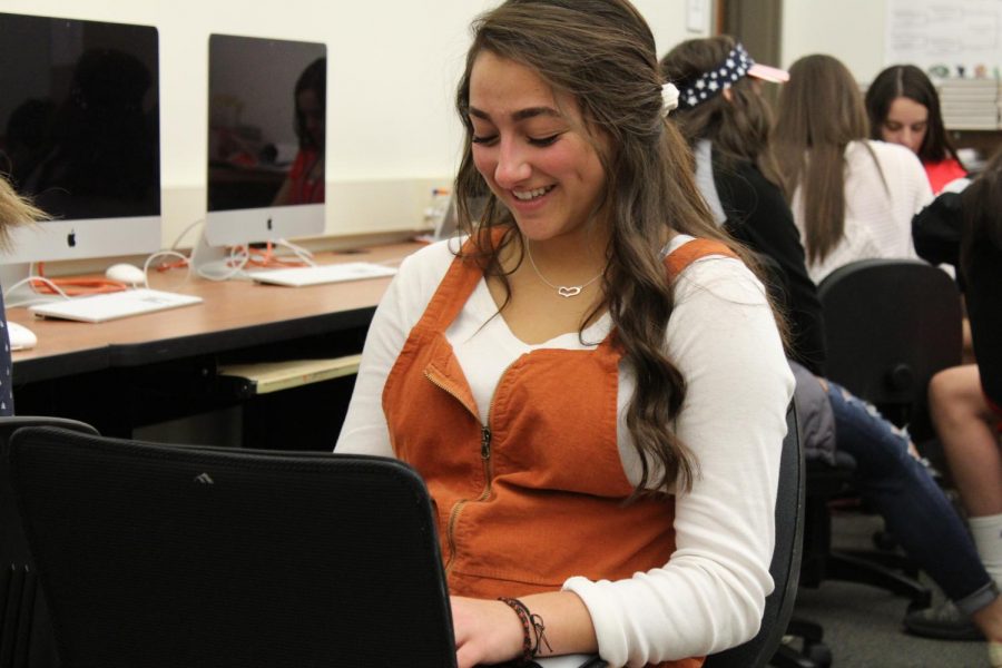 Junior Payton Asher works on an assignment on her Lenovo laptop.