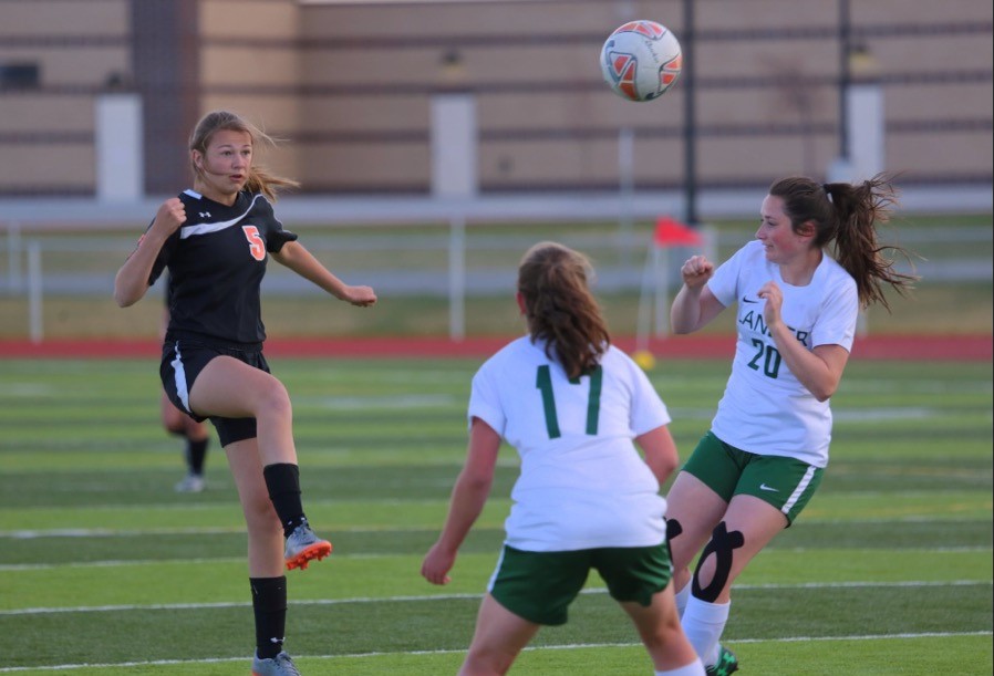 Junior Madi Fields looks to trap the soccer ball when playing the Lander Valley Tigers. 