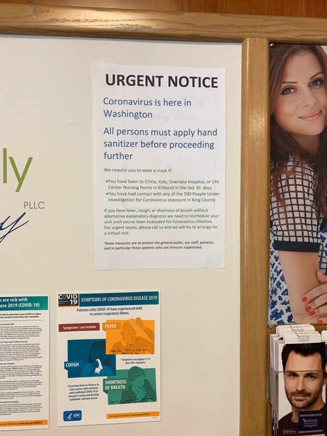 A cautionary sign posted at Miller Dermatology in Issaquah, Washington, displays a warning message about COVID-19.