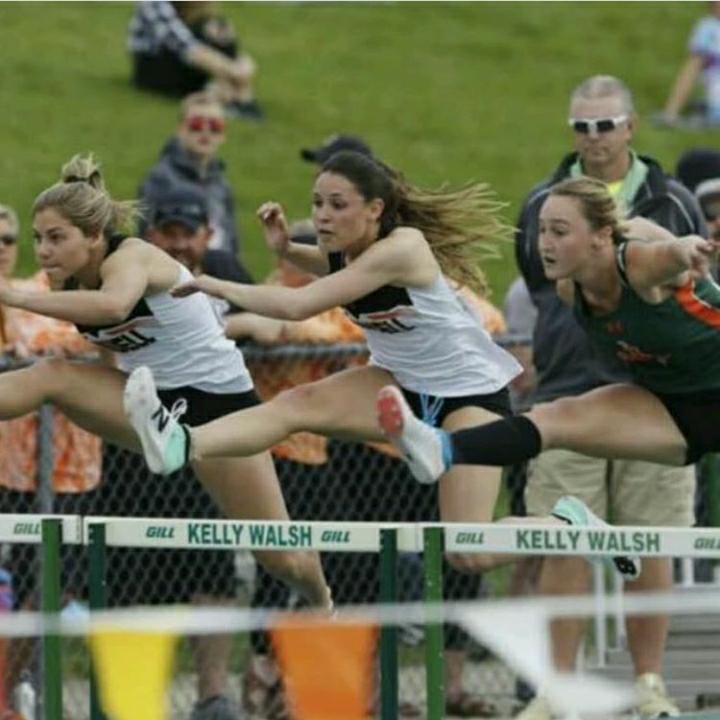 Senior Sabrina Shoopman races against two competitors, including PHS 2019 alum Caitlyn MIner (left), in the 100-meter hurdle competition last spring. 