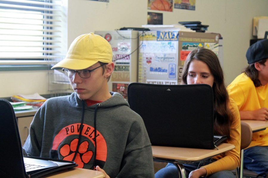 Powell High School sophomores Ben Hawley and Kameron French work on their Lenovos before the closure of schools.  