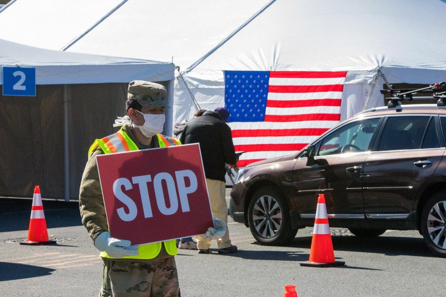 Private First Class Jose Rivera assists with traffic control at the University at Albany COVID-19 Drive-thru Test Site in support of the New York National Guard’s domestic operation in response to the coronavirus outbreak. 