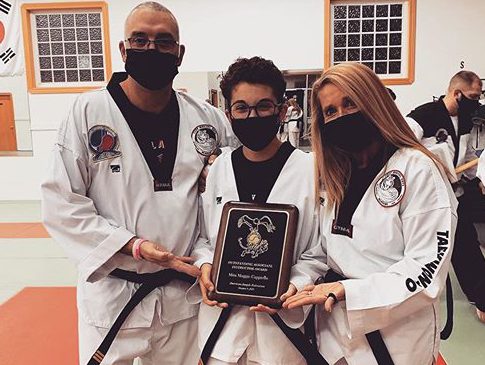 (from left) Mr. Vin Cappiello, Maggie Cappiello and Mrs. Lisa Cappiello pose with their black belts and Maggies award after completing their promotional exams Oct. 9 in Billings.