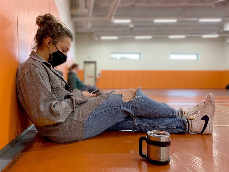 PHS senior Elsie Spomer enjoys some free time during Panther Time with her mask on and socially distanced. The school recommends staying socially distant and wearing a mask as much as possible due to COVID-19.