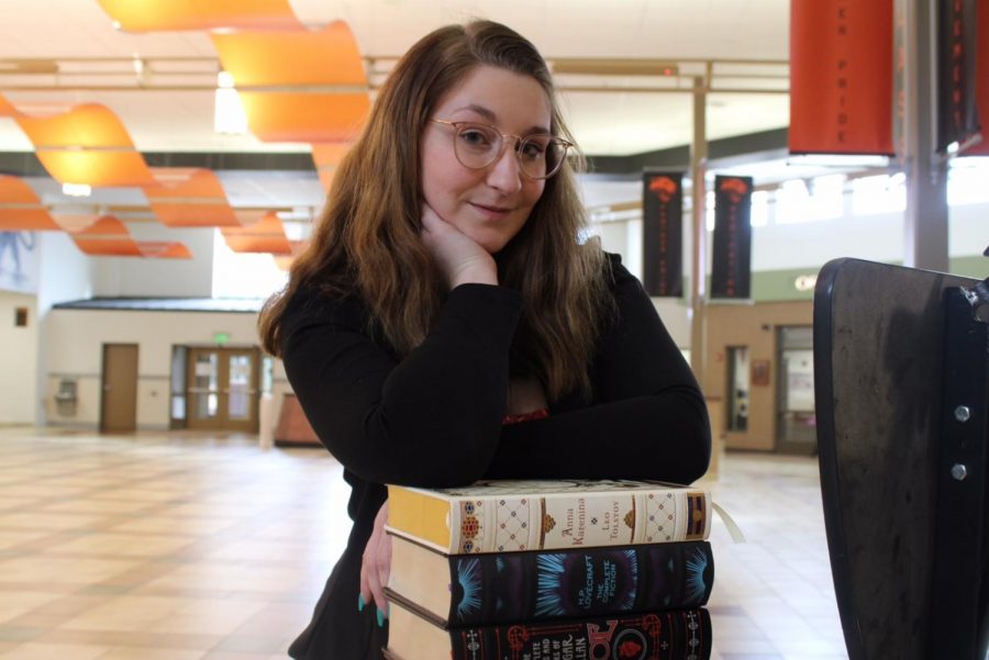 PHS senior Bailey Phillips poses with a collection of books that help to inspire her own writings.