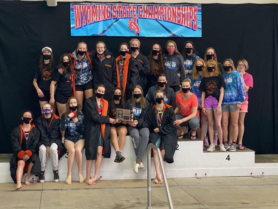 The Lady Panther swimming and diving team poses on on the podium with their third-place 3A state plaque Saturday in Laramie. The four seniors -- Elizabeth Liggett, Emma Karhu, Madison Lowery and Addy Moretti - are pictured center front, starting fourth from left.