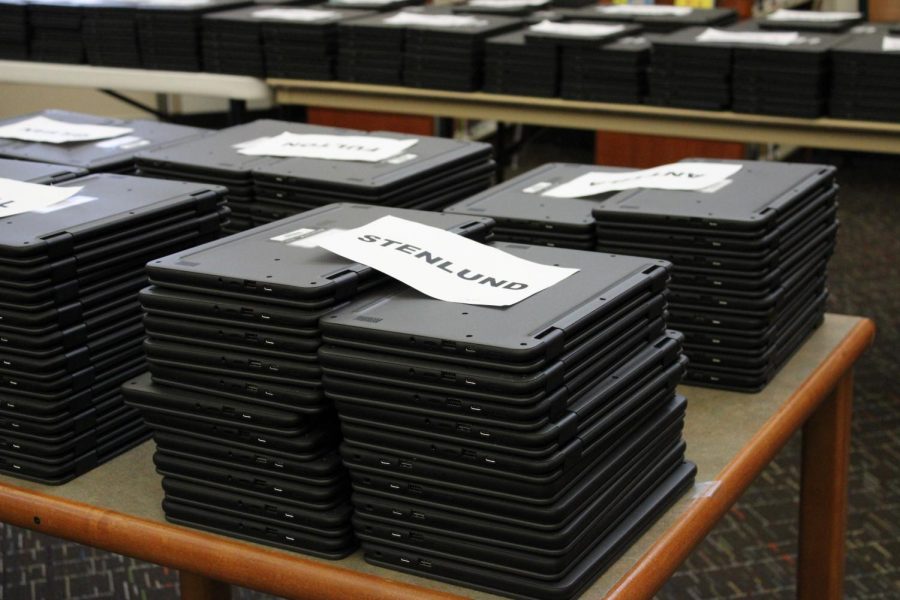 Newly arrived Chromebooks wait in the library to be checked out to PHS students