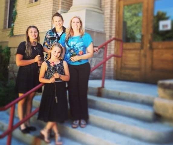 Mikayla Campbell (left), Jess Campbell (middle back), Mindy Campbel (right) and Maddie Campbell pose in front of the Park County Courthouse on April 3, 2015, the day Maddie and Mikayla officially adopted by Jess Campbell