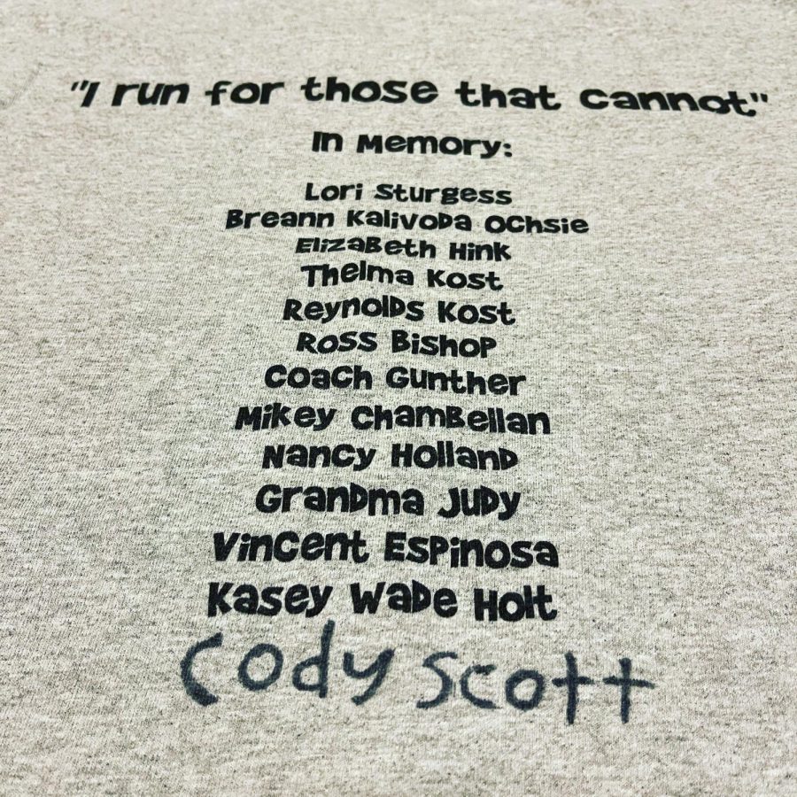 In Albuquerque, New Mexico, Mr. Holland wore this shirt in his half marathon. The names of cancer victims are written on the back to honor them.