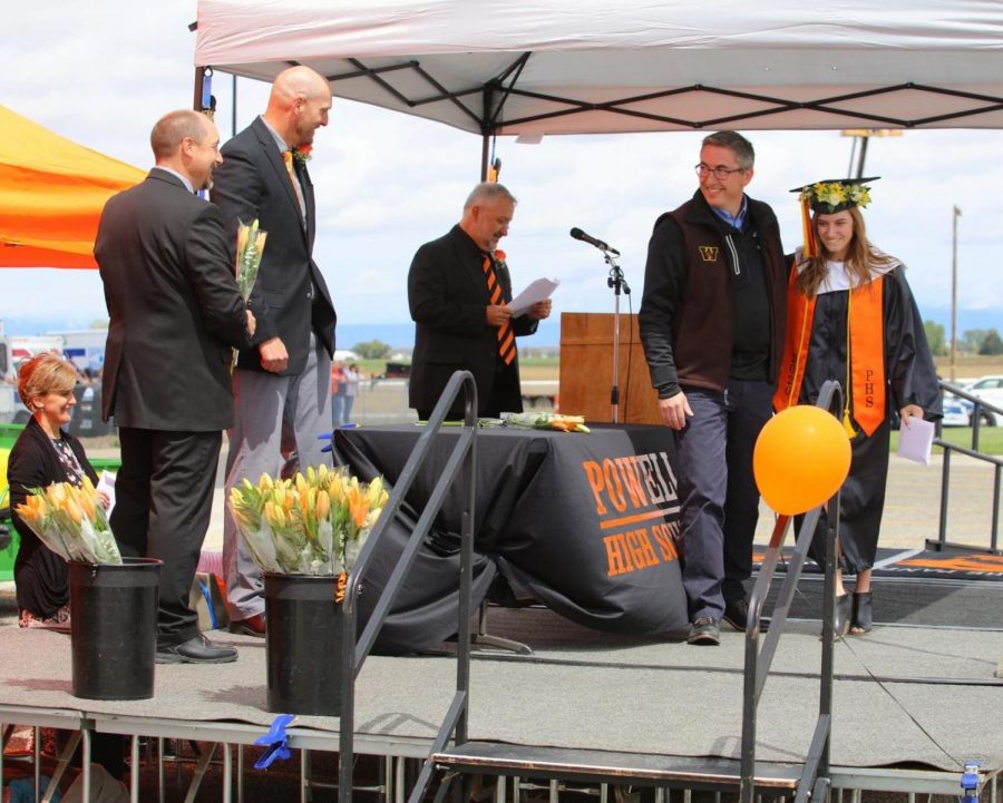 PHS+graduate+Hailee+Paul+is+escorted+by+her+father+Trace+Paul+to+receive+her+diploma+during+the+2020+graduation.+