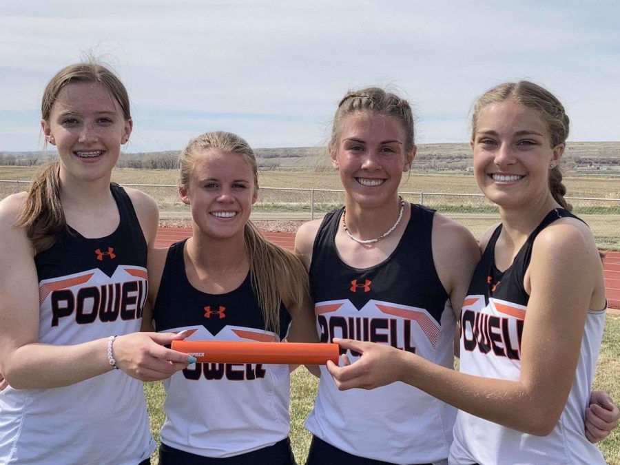 (From left) Freshman Waycee Harvey, junior Jenna Hillman, and sophomores Megan Jacobsen and Anna Bartholomew present their baton on May 1. They placed first in the 1600 Medley Relay for girls at the Lovell meet.