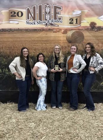 From left sophomore Brooke Bessler, senior Taylor Dye, FFA Advisor Mrs. Shannon Darough, senior Madi Harvey and sophomore Cassidy Reimer pose for a picture with their team plaque.