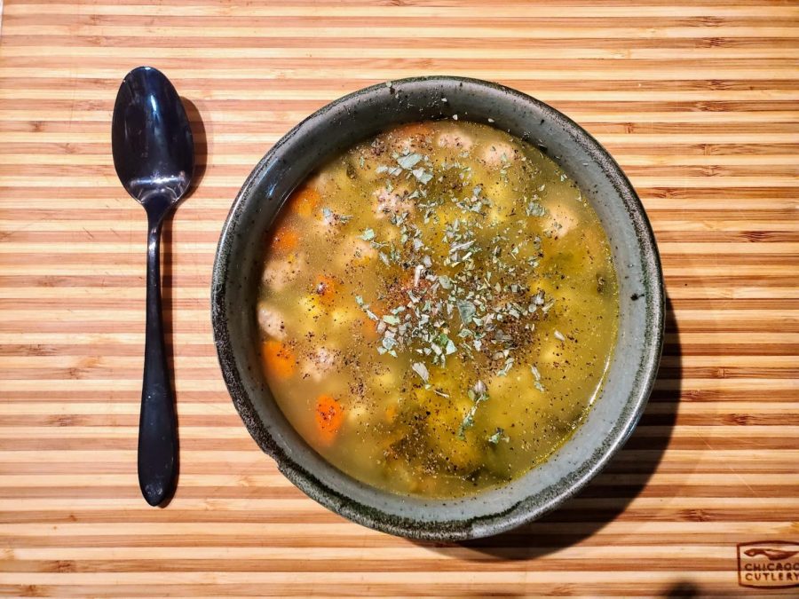 Presented is a steaming bowl of Italian wedding soup.