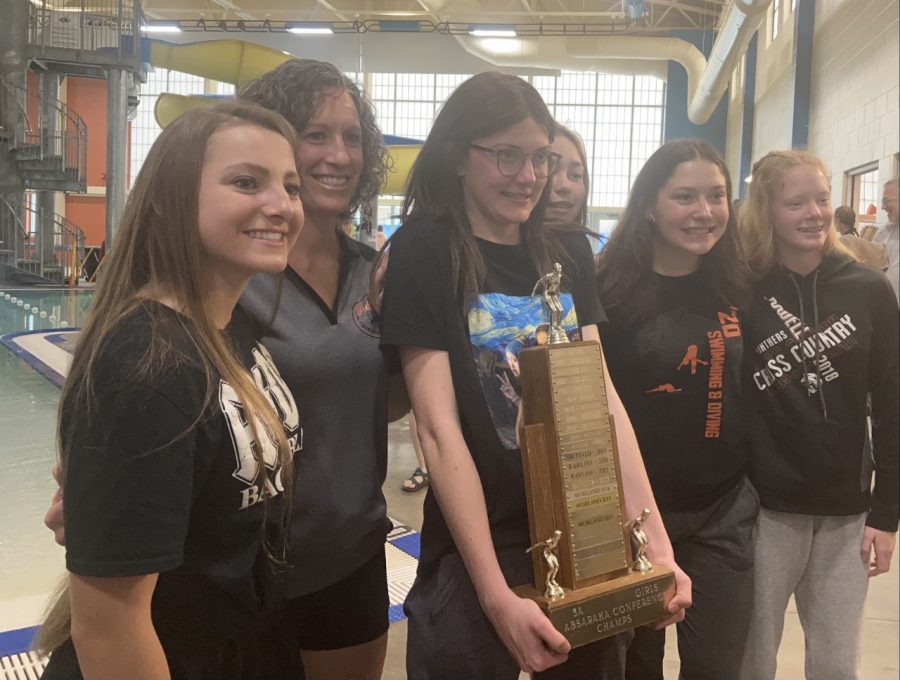 From left) Sophomore Aramonie Brinkerhoff, Coach Heather Christensen, senior Taycee Walker, juniors Yessenia Teague and Kami Jensen, and sophomore Emma Brence pose for a picture with the conference championship trophy.