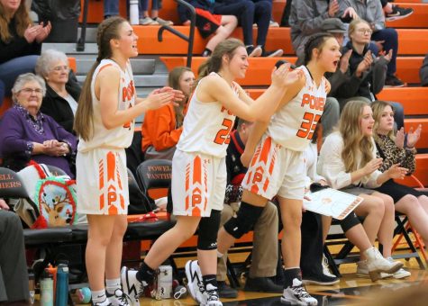 The Lady Panther bench stands up to cheer on their teammates during their game on Dec. 21, 2021.