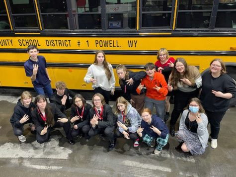The Speech and Debate team poses outside the bus after a successful State tournament.