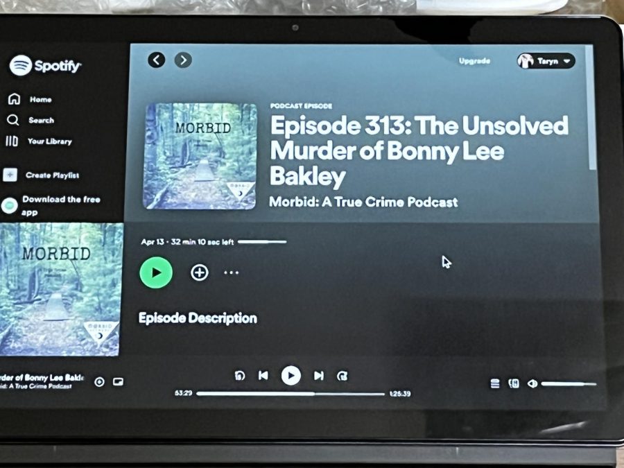 An episode from the true crime podcast, “Morbid”, is uploaded onto a laptop. 