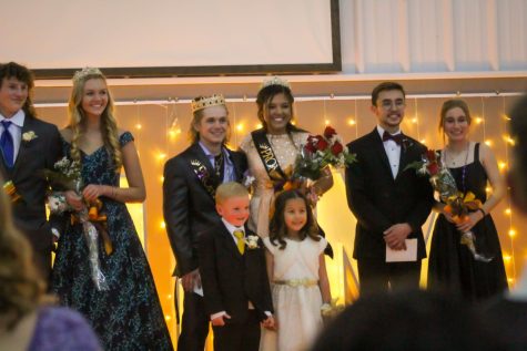 Prom royalty lines the stage as they are awarded with the designated sashes and crowns. 