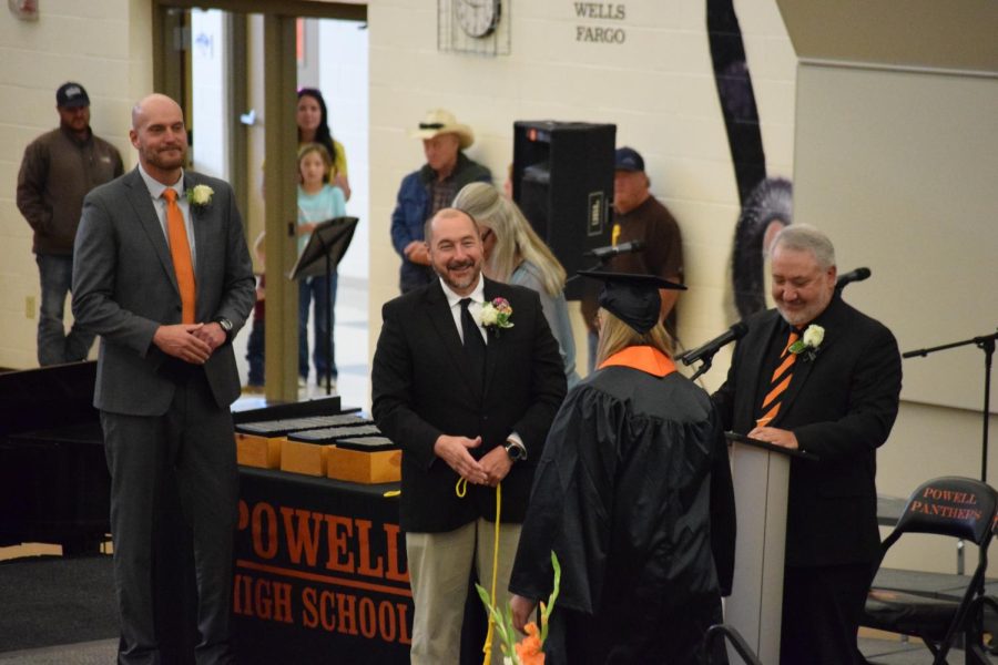 Senior Jenna Hillman walks across the stage at graduation and receives both her honors ropes and diploma from Mr. Steve Lensegrav and Mr. Tim Wormald.