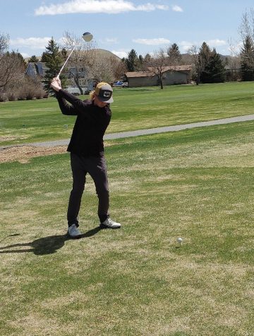 Junior Seth Siebert swings at the golf ball hoping for a nice shot to the hole.