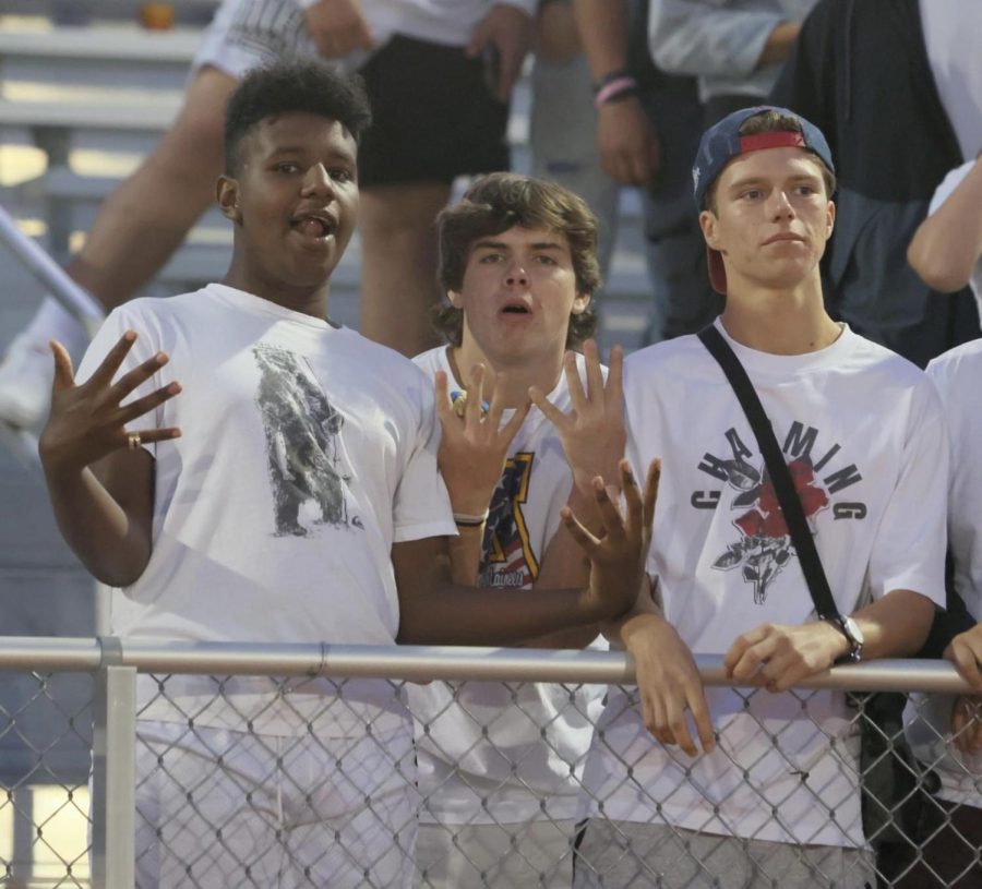  Belgian exchange student Nathan Dupont stands and cheers with seniors Yared Robirds and Ryan Cordes at a home football game. Football is just one of the many activities offered at PHS that is different from other countries.