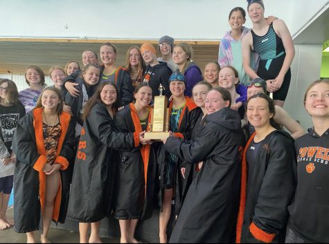 The Lady Panther Swim and Dive stands on the podium with the trophy after winning the East Absaraka Conference Championship for the second year in a row. 
