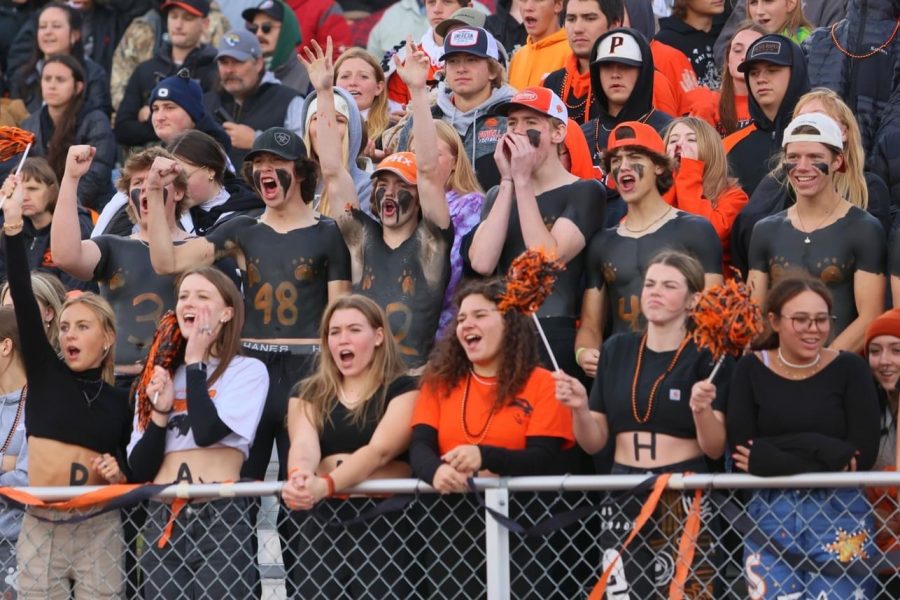 Students cheer in the PHS student section during the Homecoming football game. The Homecoming dance came after the game, where students could dance and enjoy free pizza.
