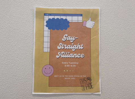 A photo displaying a Gay Straight Alliance (GSA) flyer posted in a hallway of PHS. This flyer does not include a logo; it includes only meeting times and the name of the club which adheres to school policy.  