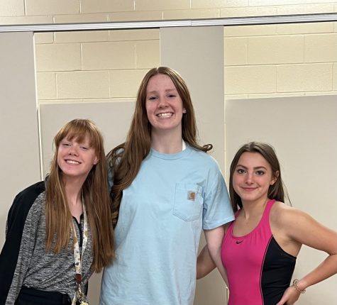 Sophomore Kate Miller stands next to fellow swimmers, juniors Kathryn Brence and Aramonie Brinkerhoff, who also obtained concussions during the competitive season.
